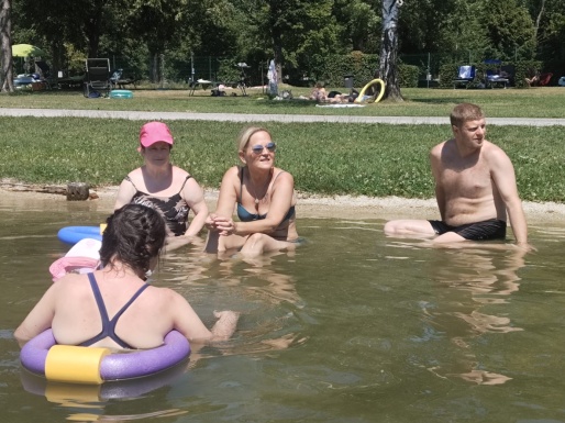 Menschen im Wasser teilweise mit Schwimmhilfe