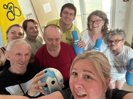 Gruppen Selfie mit Leuten die Kegeln und Bowlingkugeln hoch halten